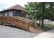 Accessible home featuring an exterior ramp, well-maintained yard, and convenient street access at 5095 Grant St, Denver, CO 80216