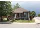Charming single-Gathering home with a well-manicured lawn, flower beds, and mature tree at 5095 Grant St, Denver, CO 80216