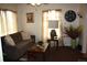 Living room featuring a neutral-toned sofa, decorative lighting, and tasteful decor at 5095 Grant St, Denver, CO 80216