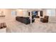 Spacious carpeted basement, featuring a large gray sofa and a TV at 11056 W Rowland Ave, Littleton, CO 80127