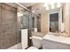 Bright bathroom featuring a walk-in shower, a vanity with a sink, and a toilet at 11056 W Rowland Ave, Littleton, CO 80127