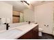 Bathroom with modern fixtures including a double vanity and a toilet at 11056 W Rowland Ave, Littleton, CO 80127
