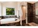 Bathroom with soaking tub by the window and a walk-in shower at 11056 W Rowland Ave, Littleton, CO 80127
