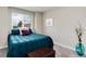 Bedroom with a comfortable bed, large window and a cozy interior at 11056 W Rowland Ave, Littleton, CO 80127