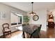 Modern dining room featuring a black marble table, pendant lighting, and backyard views at 11056 W Rowland Ave, Littleton, CO 80127