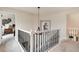 Hallway with white railings leading to upstairs bedrooms at 11056 W Rowland Ave, Littleton, CO 80127
