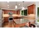 Modern gourmet kitchen featuring stainless steel appliances, granite countertops, and custom cabinetry at 11056 W Rowland Ave, Littleton, CO 80127