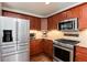 Updated kitchen with stainless appliances, granite counters and wood cabinets at 11056 W Rowland Ave, Littleton, CO 80127