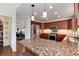 Modern kitchen features granite countertops, stainless steel appliances, and ample cabinet space at 11056 W Rowland Ave, Littleton, CO 80127