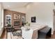 Bright living room with brick fireplace, bookshelves, and neutral-colored furniture at 11056 W Rowland Ave, Littleton, CO 80127