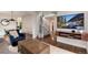 Comfortable living room with large windows and a wall-mounted television near a staircase at 11056 W Rowland Ave, Littleton, CO 80127