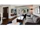 Comfortable living room with large windows and a wall-mounted television at 11056 W Rowland Ave, Littleton, CO 80127