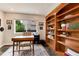 Comfortable office area with a built-in bookshelf, and natural light at 11056 W Rowland Ave, Littleton, CO 80127