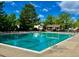 Community pool showcasing a spacious area for swimming laps, relaxing with lounge chairs, and a picnic cabana at 11056 W Rowland Ave, Littleton, CO 80127