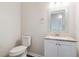 Powder room features toilet and vanity with granite countertop at 85 Uinta Way # 405, Denver, CO 80230