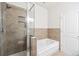 Bathroom featuring a shower with tile surround and a separate soaking tub at 85 Uinta Way # 405, Denver, CO 80230