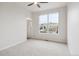 Bedroom with carpet, a ceiling fan, a large window and two doors at 85 Uinta Way # 405, Denver, CO 80230