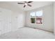 Bedroom with neutral carpet, a window, and two closets at 85 Uinta Way # 405, Denver, CO 80230