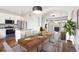 Open concept dining area with hardwood floors and easy access to the kitchen and living area at 85 Uinta Way # 405, Denver, CO 80230