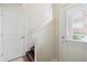 Bright entryway features white walls, staircase with dark wood steps, and door with window at 85 Uinta Way # 405, Denver, CO 80230