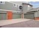 Multiple car garages are painted in a complimentary green and adorned with brick accents at 85 Uinta Way # 405, Denver, CO 80230
