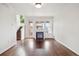 Open living room with hardwood floors, fireplace, staircase, and backyard access at 85 Uinta Way # 405, Denver, CO 80230