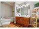 Bathroom featuring double vanity, tub, and stylish decor at 1745 Wazee St # 4G, Denver, CO 80202