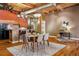 Open dining area with hardwood floors, exposed beams, and a modern chandelier, ideal for entertaining guests at 1745 Wazee St # 4G, Denver, CO 80202