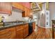 Well-equipped kitchen featuring wood cabinets, granite counters, and modern appliances, perfect for cooking enthusiasts at 1745 Wazee St # 4G, Denver, CO 80202