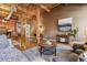 Open-concept living room featuring exposed beams, hardwood floors, and plenty of natural light at 1745 Wazee St # 4G, Denver, CO 80202