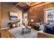 Cozy living room with exposed brick walls, hardwood floors, and comfortable seating, creating a relaxing space at 1745 Wazee St # 4G, Denver, CO 80202