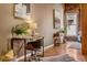Bright, airy living room featuring hardwood floors, exposed brick, and a modern desk area at 1745 Wazee St # 4G, Denver, CO 80202