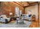 Bright living room with exposed brick, hardwood floors, and comfortable seating, perfect for relaxation and entertaining at 1745 Wazee St # 4G, Denver, CO 80202