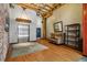 Inviting lobby space featuring exposed wooden beams, brick wall, and comfortable seating area with hardwood floors at 1745 Wazee St # 4G, Denver, CO 80202