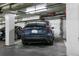 Parking garage showing Tesla car in a reserved parking space at 1745 Wazee St # 4G, Denver, CO 80202