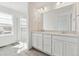 Bright bathroom featuring a double sink vanity, quartz countertops and glass shower at 24769 E 39Th Ave, Aurora, CO 80019