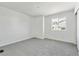 Well-lit bedroom with neutral-toned carpet and a large window, offering a serene and comfortable personal space at 24769 E 39Th Ave, Aurora, CO 80019
