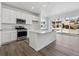 Modern kitchen with stainless steel appliances, white cabinets, and large island at 24769 E 39Th Ave, Aurora, CO 80019