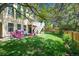 Spacious backyard with lush green grass, white deck with stairs, and play area for children at 1762 Red Fox Pl, Highlands Ranch, CO 80126