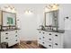 Bright bathroom featuring dual vanities with dark countertops and wood-look floors at 1762 Red Fox Pl, Highlands Ranch, CO 80126