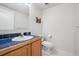 Bathroom features a blue tiled counter, modern toilet, and picture on the wall at 1762 Red Fox Pl, Highlands Ranch, CO 80126