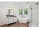 Bright bathroom featuring soaking tub, stylish vanity, and a glass-enclosed shower at 1762 Red Fox Pl, Highlands Ranch, CO 80126