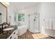 Bright bathroom featuring soaking tub, stylish vanity, and a glass-enclosed shower at 1762 Red Fox Pl, Highlands Ranch, CO 80126