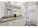 Bathroom with double vanity, granite countertop, and shower with yellow-patterned curtain at 1762 Red Fox Pl, Highlands Ranch, CO 80126