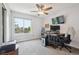 Bright bedroom featuring a ceiling fan, large window with view, and dedicated desk and work area at 1762 Red Fox Pl, Highlands Ranch, CO 80126