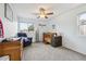 Cozy bedroom featuring a wood crib, comfortable chair, and a bright window at 1762 Red Fox Pl, Highlands Ranch, CO 80126