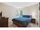 Comfortable bedroom featuring wood-look floors, ample natural light, and serene views at 1762 Red Fox Pl, Highlands Ranch, CO 80126