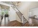 Bright foyer featuring a staircase with carpeted treads and wooden floors at 1762 Red Fox Pl, Highlands Ranch, CO 80126