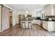 Bright kitchen features stainless appliances, granite counters, and a stylish sliding barn door at 1762 Red Fox Pl, Highlands Ranch, CO 80126