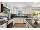 Modern kitchen with sleek countertops, stainless appliances, and ample natural light from the windows at 1762 Red Fox Pl, Highlands Ranch, CO 80126